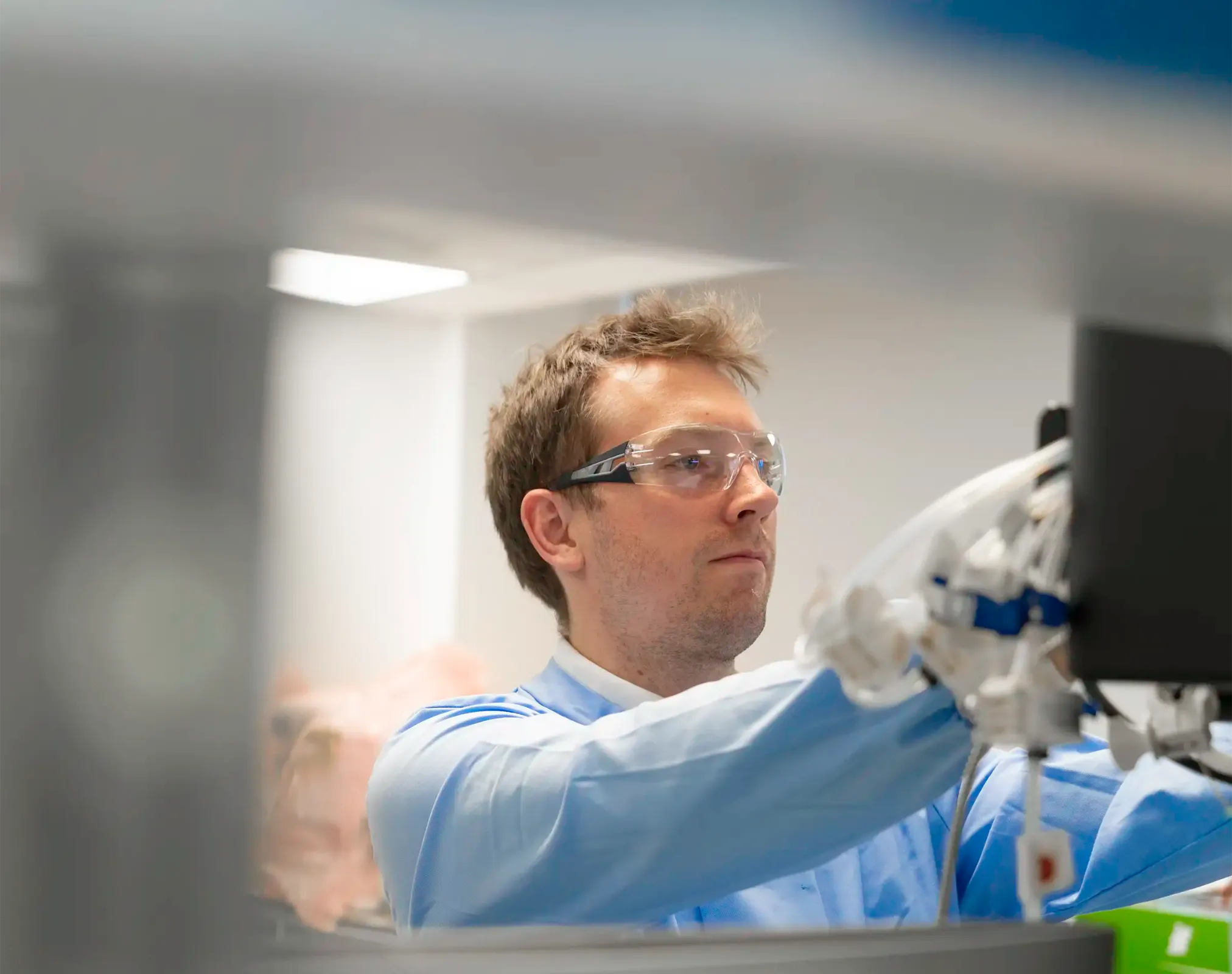 Scientist adjusting laboratory equipment