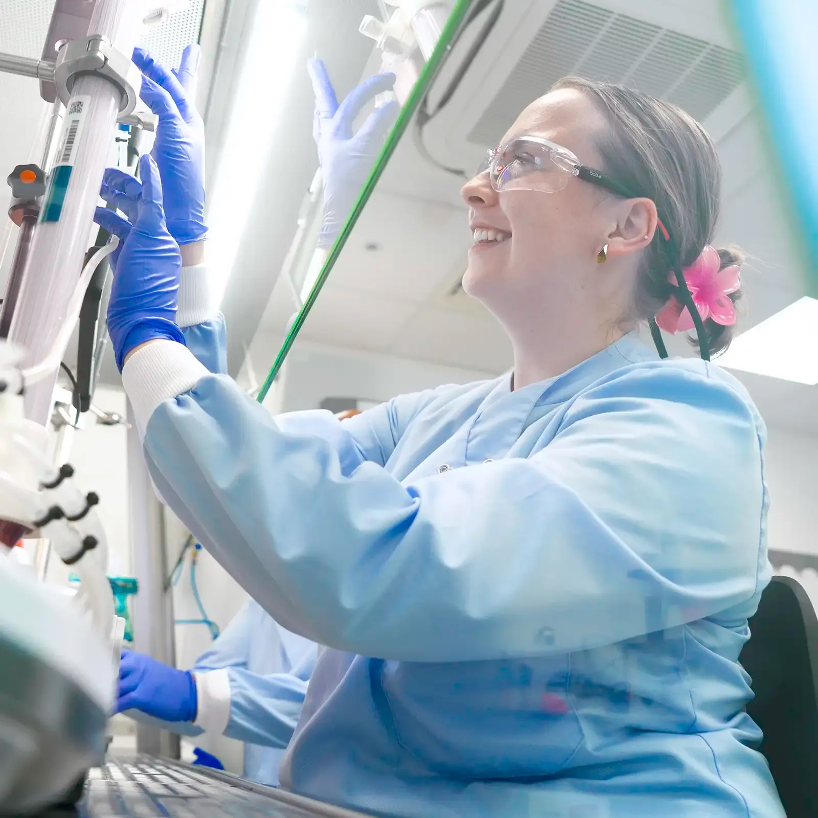 Scientist adjusting laboratory equipment