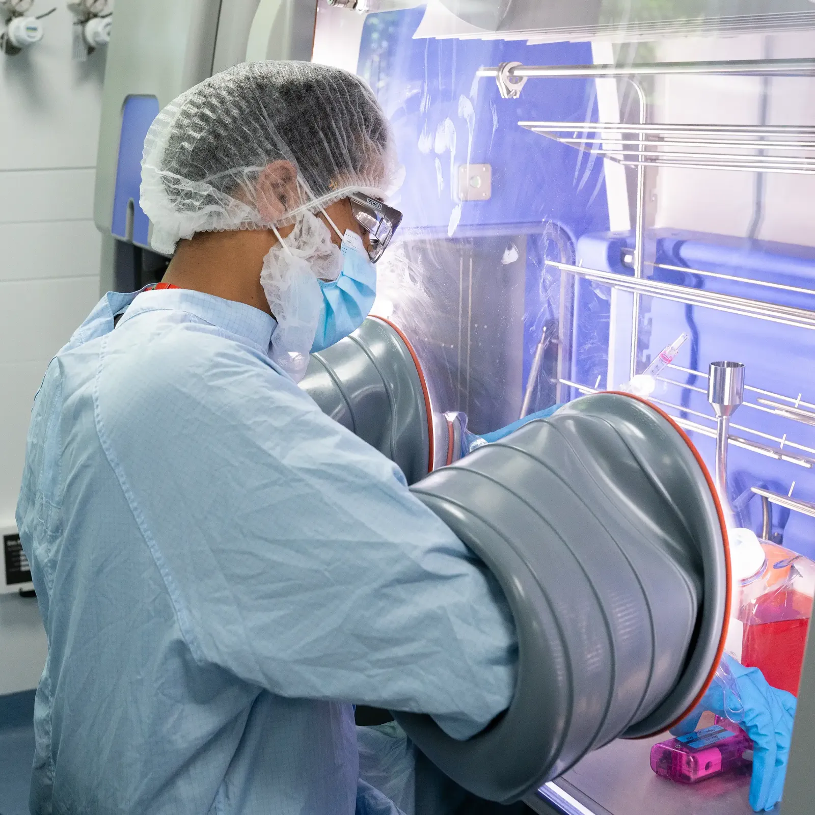 Laboratory scientist working with a clean room glovebox