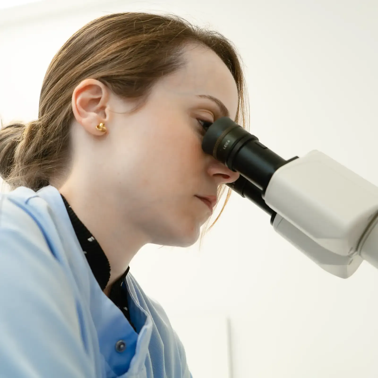 Scientist looking into a microscope